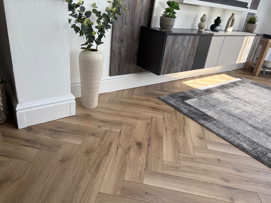 ThermaSkirt below panelled walls in a styled lounge with herringbone flooring