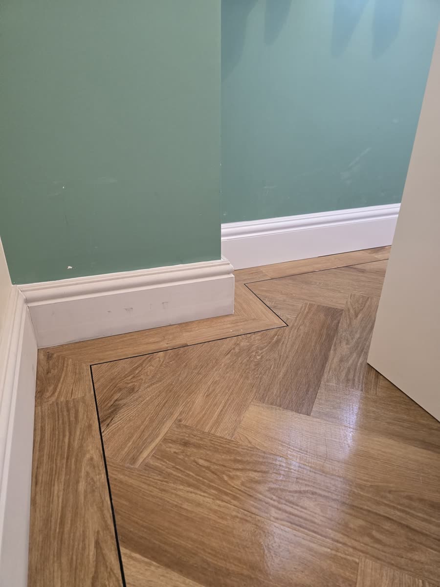 ThermaSkirt corner over golden herringbone flooring